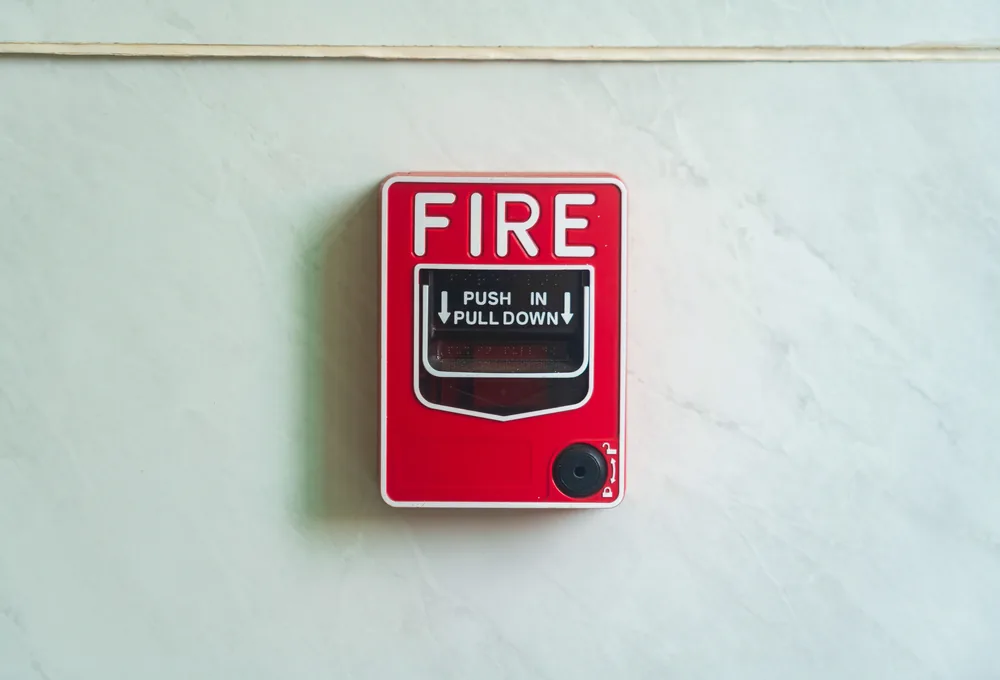 Red wall-mounted fire alarm